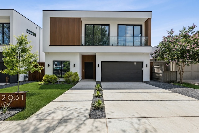 2031 Cullen Ave, Dallas, TX 75206 - contemporary house featuring stucco siding, a garage, concrete driveway, and a balcony
