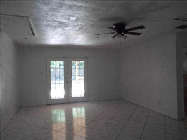 337 W Coral Way, Grand Prairie, TX 75051 - spare room with french doors, a ceiling fan, light tile patterned floors, and attic access