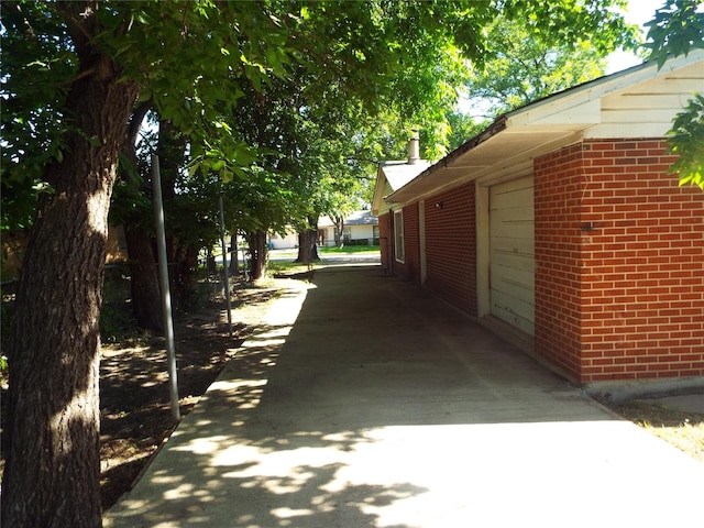 337 W Coral Way, Grand Prairie, TX 75051 - view of side of home featuring brick siding and a garage