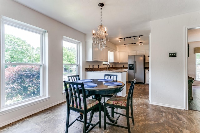 2831 Creekwood Ct, Grapevine, TX 76051 - dining room featuring baseboards and a chandelier