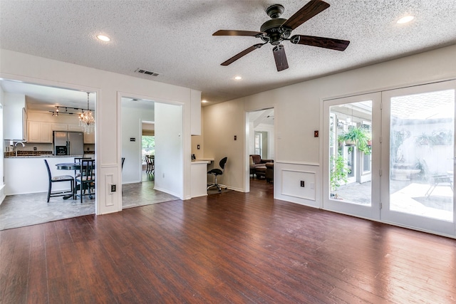 2831 Creekwood Ct, Grapevine, TX 76051 - living room featuring dark wood-style floors, a textured ceiling, a ceiling fan, recessed lighting, and a chandelier