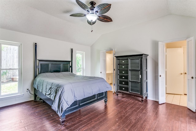 2831 Creekwood Ct, Grapevine, TX 76051 - bedroom with vaulted ceiling, wood finished floors, baseboards, a ceiling fan, and connected bathroom