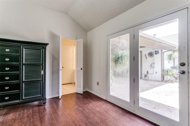 2831 Creekwood Ct, Grapevine, TX 76051 - unfurnished bedroom featuring access to exterior, vaulted ceiling, multiple windows, wood finished floors, and baseboards