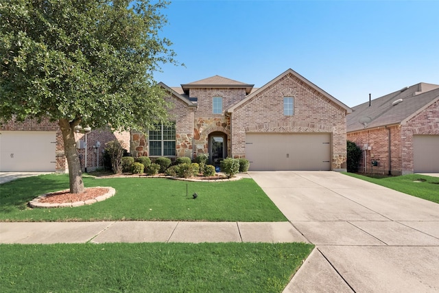 1804 Shoebill Dr, Little Elm, TX 75068 - view of front of home with driveway, a front lawn, a garage, brick siding, and a shingled roof