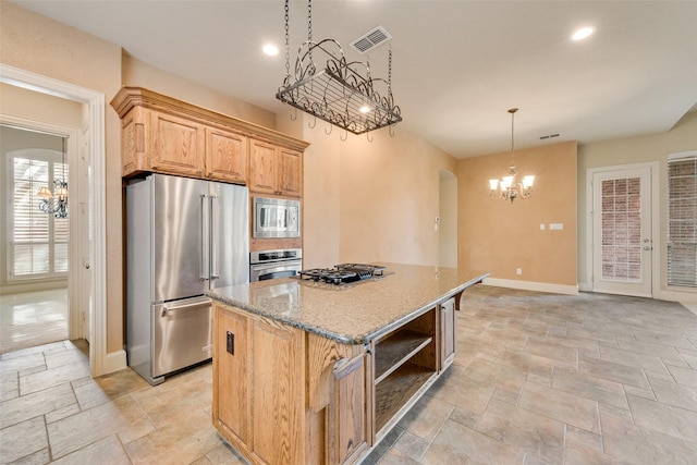 1542 Sandia Ln, Frisco, TX 75033 - kitchen featuring stainless steel appliances, a chandelier, stone tile flooring, light stone counters, and recessed lighting