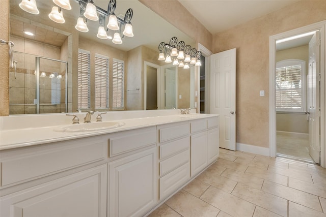 1542 Sandia Ln, Frisco, TX 75033 - full bath with a chandelier, double vanity, tile patterned flooring, a shower stall, and baseboards