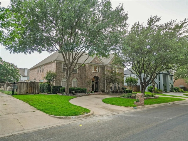 6717 Savannah Ln, Fort Worth, TX 76132 - colonial-style house with a gate and brick siding