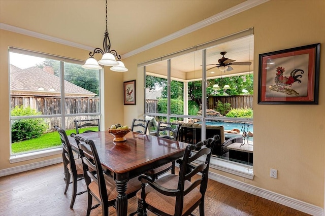 6717 Savannah Ln, Fort Worth, TX 76132 - dining room featuring baseboards, wood finished floors, crown molding, and ceiling fan