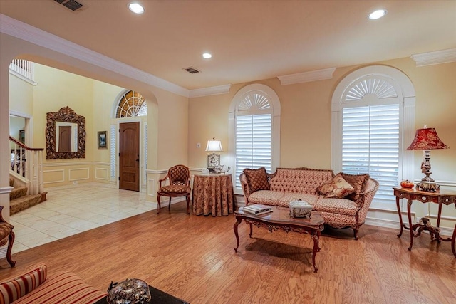 6717 Savannah Ln, Fort Worth, TX 76132 - living room with ornamental molding, light wood-style floors, stairway, a decorative wall, and arched walkways
