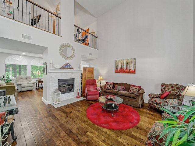 525 Sir Roland Dr, Grand Prairie, TX 75052 - living area with wood finished floors, a glass covered fireplace, and a towering ceiling