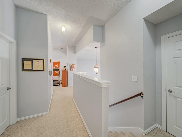 525 Sir Roland Dr, Grand Prairie, TX 75052 - hall featuring an upstairs landing, carpet flooring, a textured ceiling, and baseboards