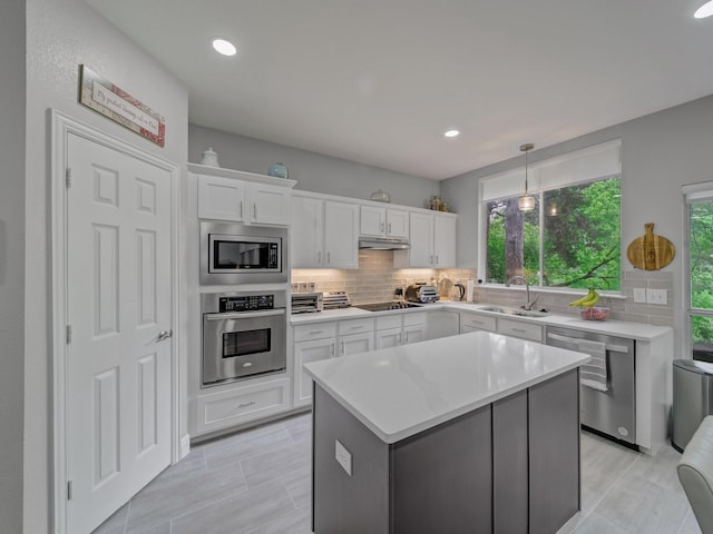 525 Sir Roland Dr, Grand Prairie, TX 75052 - kitchen with stainless steel appliances, a sink, white cabinets, decorative backsplash, and recessed lighting