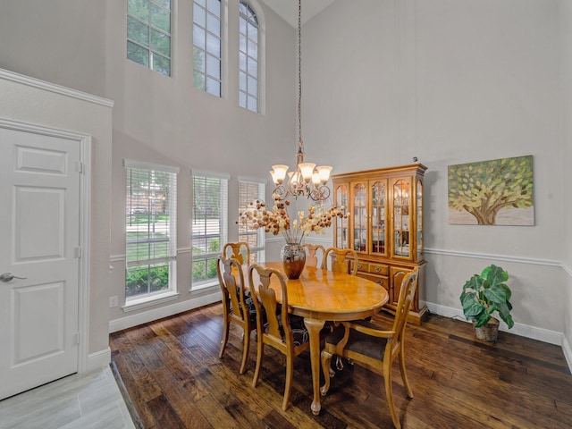 525 Sir Roland Dr, Grand Prairie, TX 75052 - dining area with a chandelier, a high ceiling, wood finished floors, and baseboards