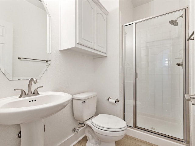 2231 Cold Water Dr, Prosper, TX 75078 - bathroom featuring a stall shower, toilet, baseboards, and a sink