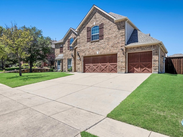 2231 Cold Water Dr, Prosper, TX 75078 - view of front of property with a front lawn, concrete driveway, roof with shingles, an attached garage, and brick siding