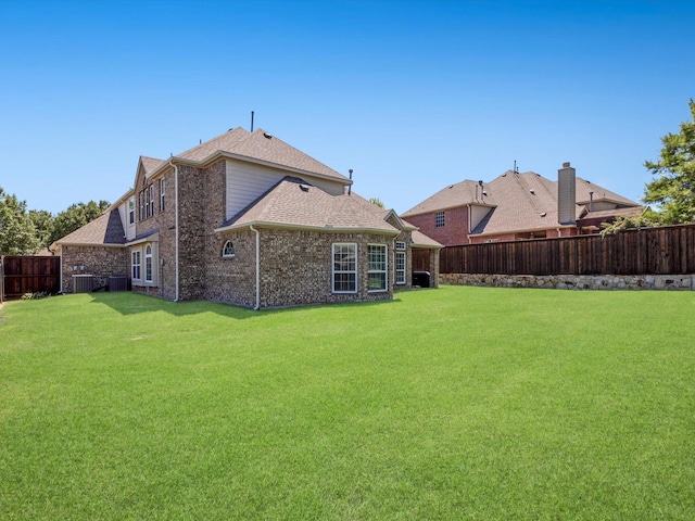 2231 Cold Water Dr, Prosper, TX 75078 - back of house featuring central air condition unit, a shingled roof, and brick siding