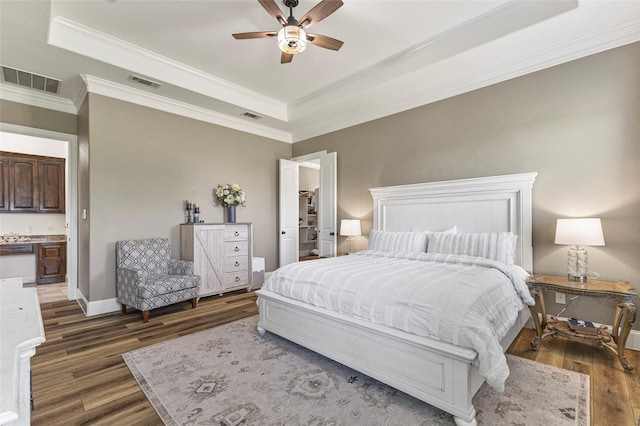 204 Lost Spur Ln, Royse City, TX 75189 - bedroom with a raised ceiling, wood finished floors, crown molding, baseboards, and a ceiling fan