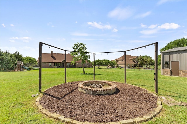 204 Lost Spur Ln, Royse City, TX 75189 - view of grassy yard with a playground and an outdoor fire pit