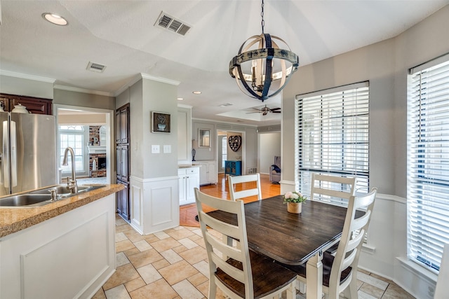 2332 Heatherwoods Way, Carrollton, TX 75007 - dining room with a chandelier, crown molding, a brick fireplace, wainscoting, and recessed lighting