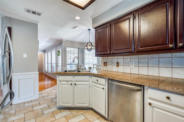 2332 Heatherwoods Way, Carrollton, TX 75007 - kitchen with tile countertops, appliances with stainless steel finishes, a sink, white cabinets, and a peninsula