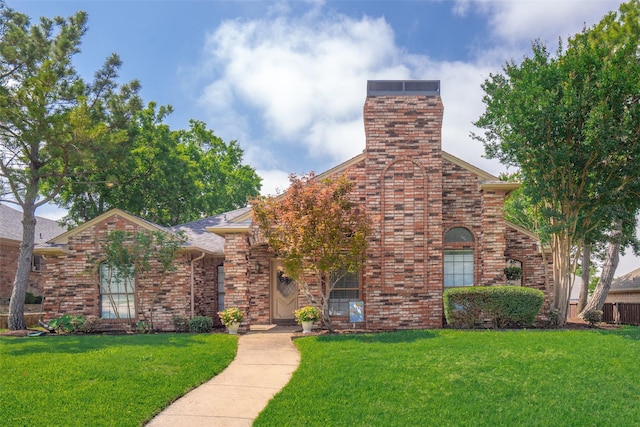 2332 Heatherwoods Way, Carrollton, TX 75007 - view of front of property with a front lawn, brick siding, and a chimney