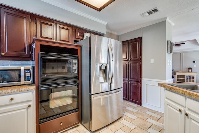 2332 Heatherwoods Way, Carrollton, TX 75007 - kitchen with stainless steel appliances, light countertops, ornamental molding, a sink, and a decorative wall
