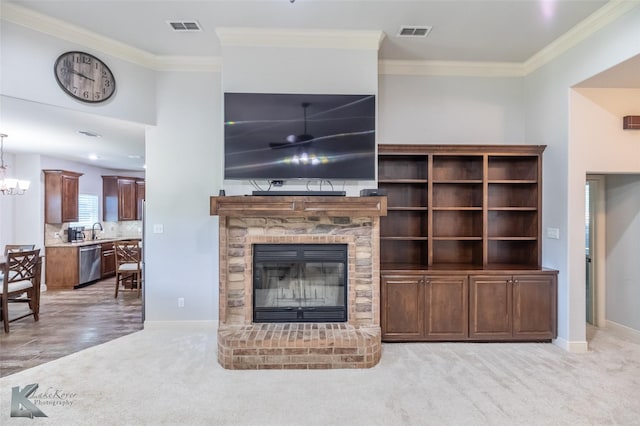 4709 Spring Creek Rd, Abilene, TX 79602 - carpeted living room with ornamental molding, a fireplace, baseboards, a chandelier, and a sink