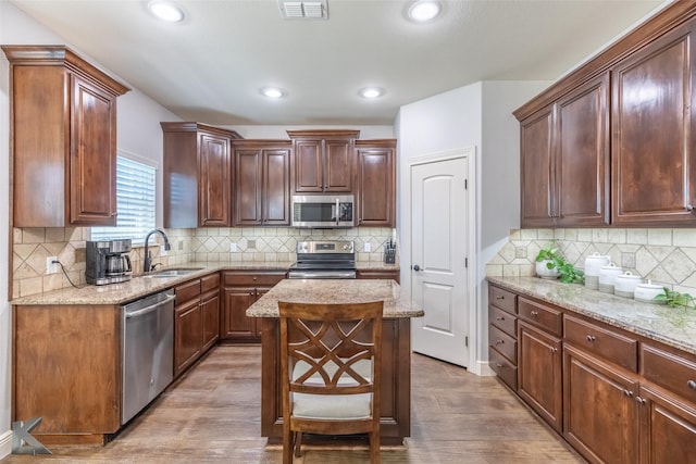4709 Spring Creek Rd, Abilene, TX 79602 - kitchen with stainless steel appliances, a sink, backsplash, light stone counters, and recessed lighting