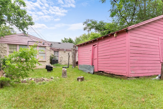 1343 Arizona Ave, Dallas, TX 75216 - view of grassy yard with an outbuilding and cooling unit