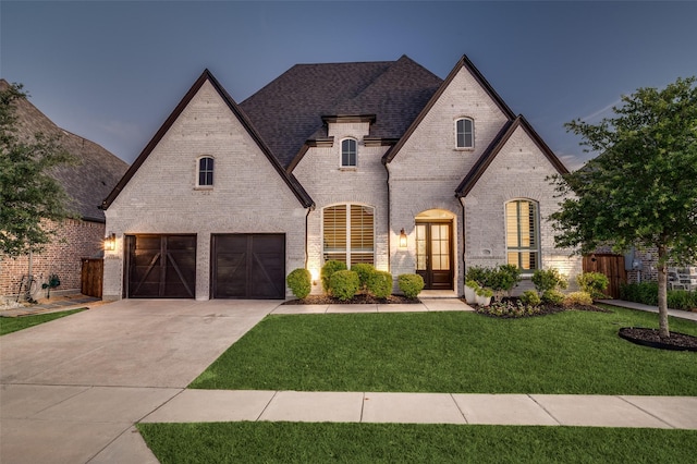 3201 Sunday Silence Ln, Celina, TX 75009 - french country style house with driveway, brick siding, a garage, and roof with shingles