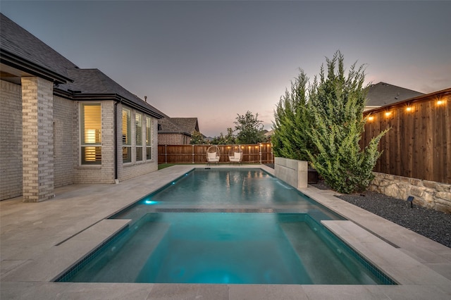 3201 Sunday Silence Ln, Celina, TX 75009 - pool at dusk featuring a fenced backyard, a pool with connected hot tub, and a patio