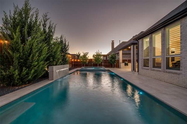 3201 Sunday Silence Ln, Celina, TX 75009 - pool at dusk with a pool with connected hot tub and a patio