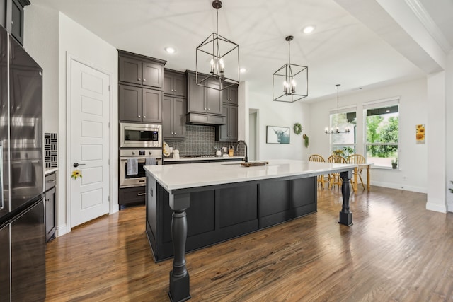 418 Sundance Trl, Sunnyvale, TX 75182 - kitchen with appliances with stainless steel finishes, a chandelier, tasteful backsplash, light countertops, and dark wood finished floors