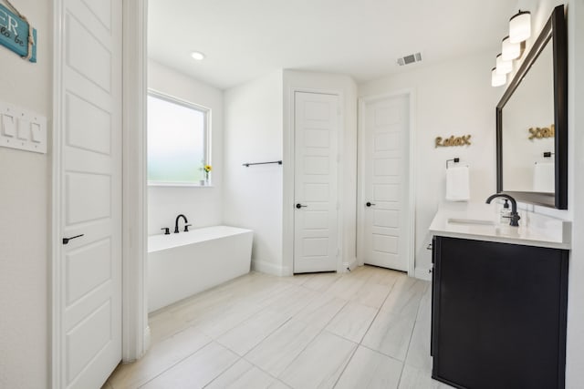 418 Sundance Trl, Sunnyvale, TX 75182 - bathroom with a freestanding bath, vanity, tile patterned flooring, recessed lighting, and baseboards