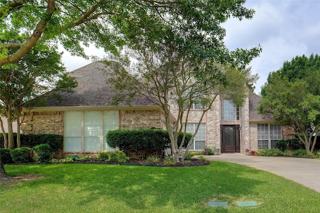 4112 Paddington Ln, Colleyville, TX 76034 - view of front of house with brick siding, a front lawn, and roof with shingles