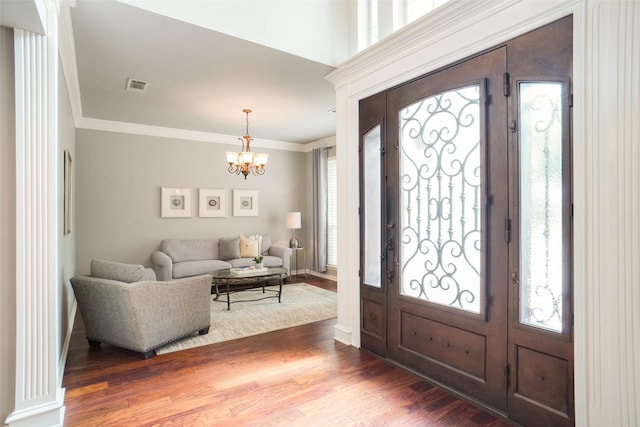 4112 Paddington Ln, Colleyville, TX 76034 - foyer entrance featuring a chandelier, ornamental molding, plenty of natural light, and wood finished floors