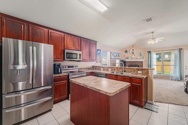 4720 Topaz Ln, Granbury, TX 76049 - kitchen featuring appliances with stainless steel finishes, a sink, open floor plan, a peninsula, and light tile patterned floors