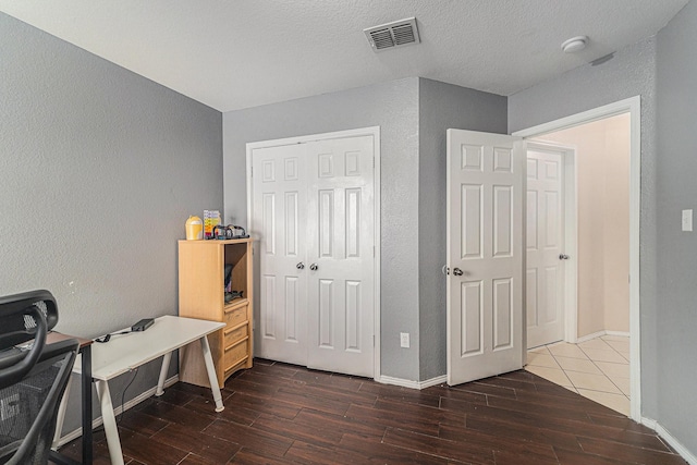 4720 Topaz Ln, Granbury, TX 76049 - office with dark wood-style floors, baseboards, a textured wall, and a textured ceiling
