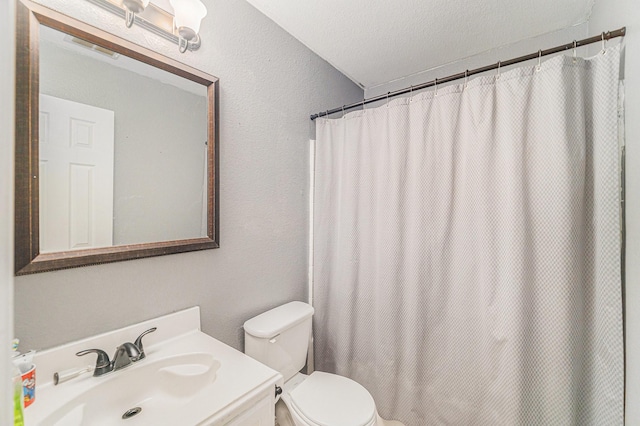 4720 Topaz Ln, Granbury, TX 76049 - bathroom featuring vanity, toilet, a textured wall, and a textured ceiling