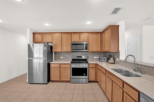 8857 Shore Crest Rd, Frisco, TX 75036 - kitchen with appliances with stainless steel finishes, a sink, backsplash, light countertops, and recessed lighting