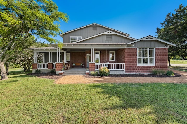 3829 Fm 896, Leonard, TX 75452 - view of front of property with covered porch, brick siding, and a front lawn