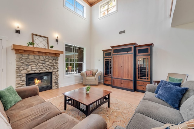 3829 Fm 896, Leonard, TX 75452 - living area with a towering ceiling, light wood finished floors, beverage cooler, and a stone fireplace