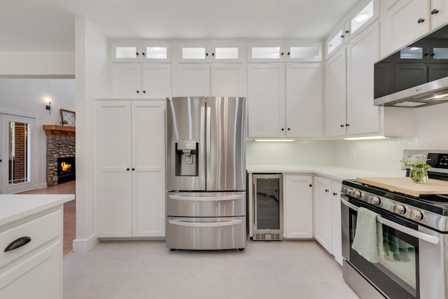 3829 Fm 896, Leonard, TX 75452 - kitchen featuring appliances with stainless steel finishes, beverage cooler, white cabinetry, and light countertops