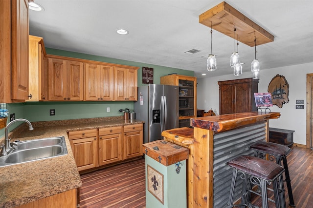 227 W Lipan Dr, Lipan, TX 76462 - kitchen with stainless steel refrigerator with ice dispenser, a sink, a center island, dark wood-style floors, and a kitchen breakfast bar