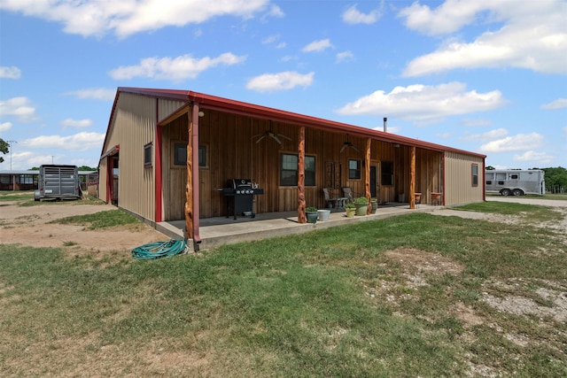 227 W Lipan Dr, Lipan, TX 76462 - back of house with a patio area, a lawn, ceiling fan, and board and batten siding