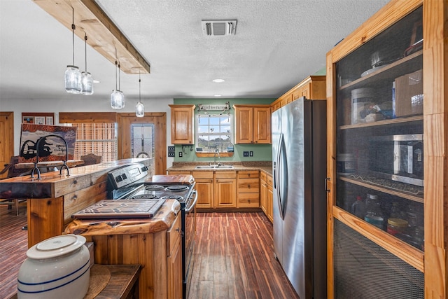 227 W Lipan Dr, Lipan, TX 76462 - kitchen with appliances with stainless steel finishes, a sink, dark wood finished floors, a center island, and a textured ceiling