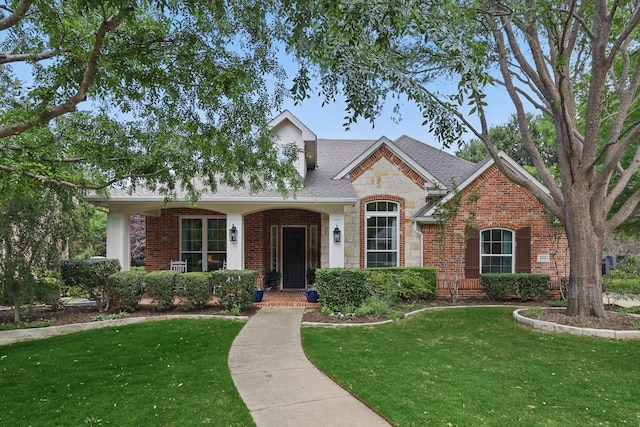 1416 Basil Dr, Flower Mound, TX 75028 - traditional home featuring a front yard, brick siding, stone siding, and a shingled roof