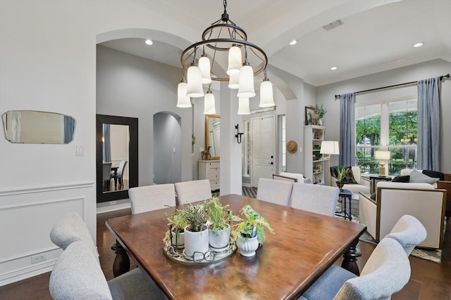 1416 Basil Dr, Flower Mound, TX 75028 - dining room featuring arched walkways, dark wood-style floors, recessed lighting, and crown molding