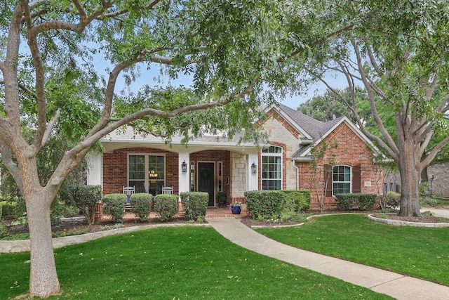 1416 Basil Dr, Flower Mound, TX 75028 - view of front of house featuring a front yard, brick siding, and stone siding