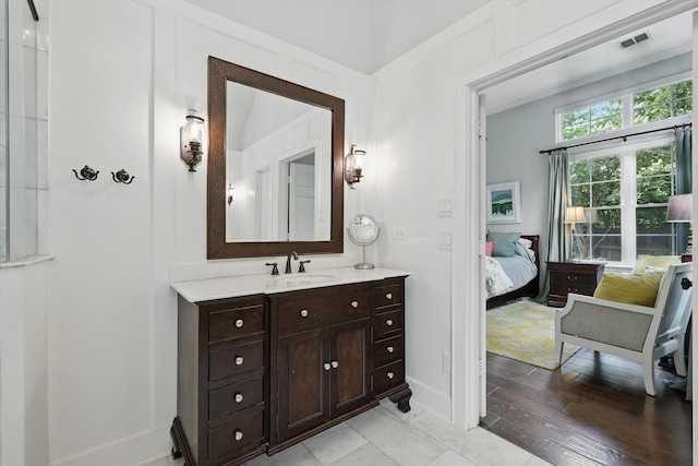 1416 Basil Dr, Flower Mound, TX 75028 - bathroom with vanity, baseboards, ensuite bathroom, and wood finished floors